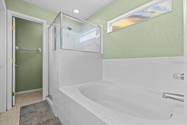 full bath with tile patterned floors, a garden tub, and a stall shower