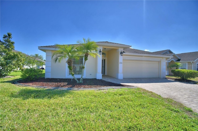 view of front of property featuring stucco siding, an attached garage, decorative driveway, and a front lawn