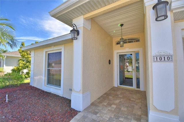 property entrance featuring stucco siding