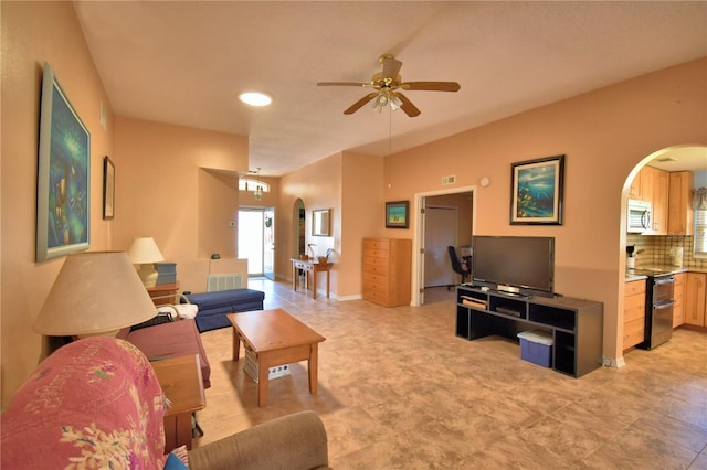 living room with arched walkways, visible vents, and ceiling fan