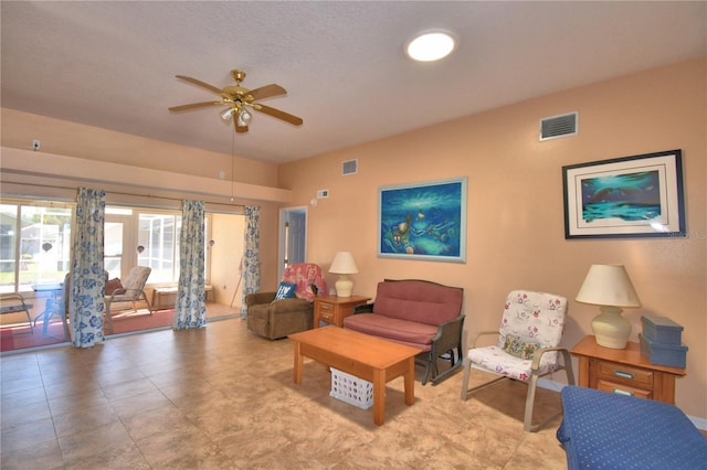 living room featuring visible vents and ceiling fan