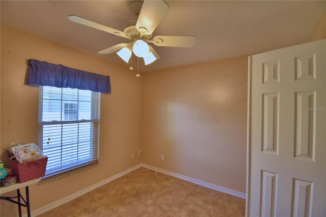 spare room featuring baseboards and ceiling fan