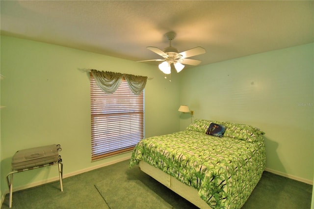 carpeted bedroom with a ceiling fan and baseboards