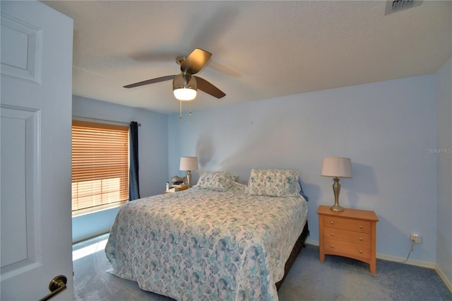 carpeted bedroom with visible vents, a ceiling fan, and baseboards