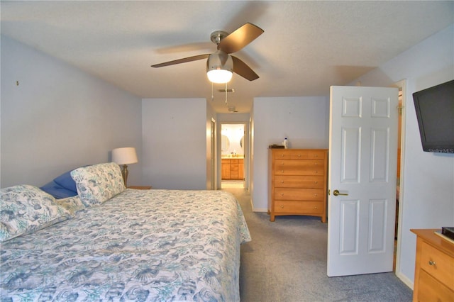 carpeted bedroom featuring visible vents, baseboards, connected bathroom, and a ceiling fan