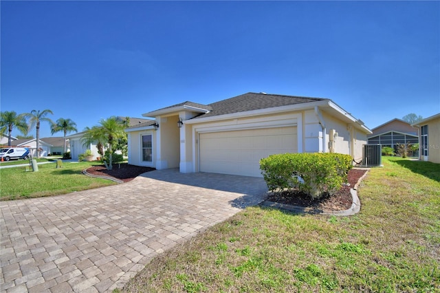 view of front of home featuring stucco siding, decorative driveway, a front lawn, and an attached garage