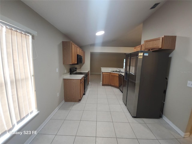 1346 Rolling River Rd, Deland, FL 32720 - kitchen featuring black appliances, vaulted ceiling, a sink, light countertops, and light tile patterned flooring