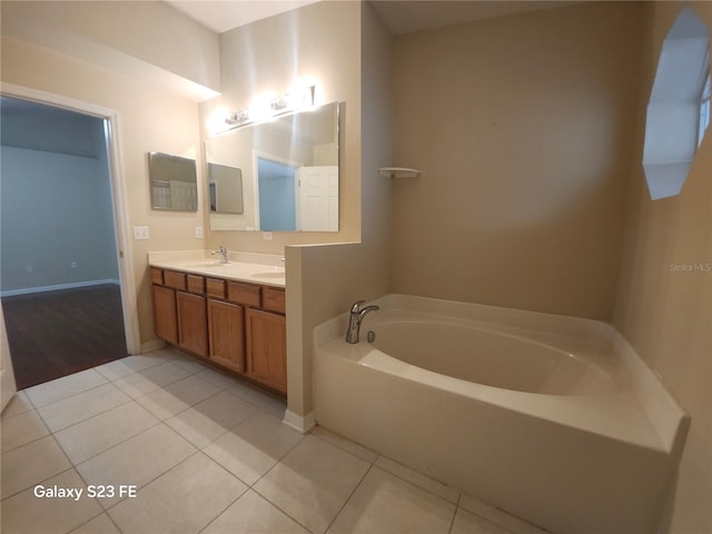 1346 Rolling River Rd, Deland, FL 32720 - bathroom with double vanity, a bath, tile patterned flooring, and baseboards