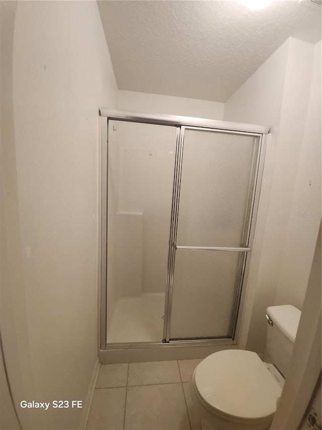 1346 Rolling River Rd, Deland, FL 32720 - full bathroom with toilet, a shower stall, a textured ceiling, tile patterned flooring, and baseboards