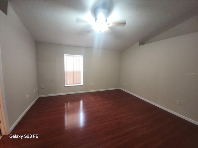 1346 Rolling River Rd, Deland, FL 32720 - empty room featuring a ceiling fan, dark wood-type flooring, baseboards, lofted ceiling, and a textured ceiling