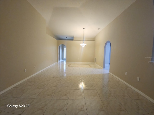 1346 Rolling River Rd, Deland, FL 32720 - unfurnished room with arched walkways, lofted ceiling, a chandelier, and baseboards