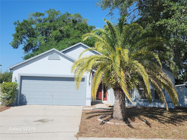 1346 Rolling River Rd, Deland, FL 32720 - view of front of property with concrete driveway, stucco siding, and a garage