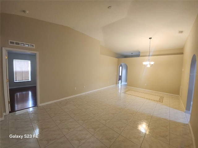 1346 Rolling River Rd, Deland, FL 32720 - empty room with arched walkways, baseboards, light tile patterned flooring, and high vaulted ceiling