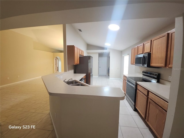 1346 Rolling River Rd, Deland, FL 32720 - kitchen featuring appliances with stainless steel finishes, a sink, vaulted ceiling, light tile patterned floors, and light countertops