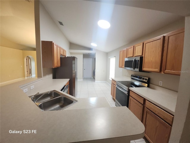 1346 Rolling River Rd, Deland, FL 32720 - kitchen featuring appliances with stainless steel finishes, a sink, vaulted ceiling, light tile patterned floors, and light countertops