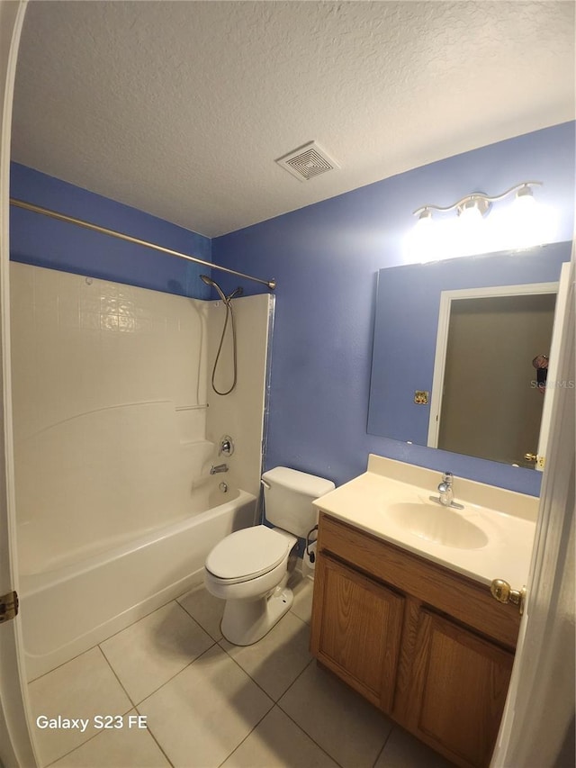 1346 Rolling River Rd, Deland, FL 32720 - bathroom featuring toilet, vanity, shower / tub combination, tile patterned flooring, and a textured ceiling