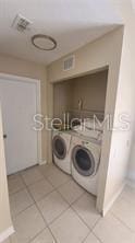 1346 Rolling River Rd, Deland, FL 32720 - laundry room with independent washer and dryer, light tile patterned flooring, and baseboards