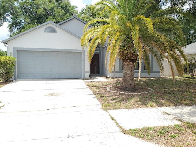 1346 Rolling River Rd, Deland, FL 32720 - view of front of property with driveway, a garage, and stucco siding