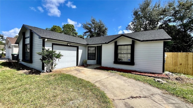 single story home with concrete driveway, roof with shingles, an attached garage, fence, and a front yard