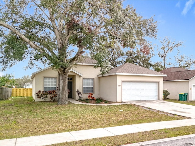 ranch-style house with a garage, fence, driveway, stucco siding, and a front lawn