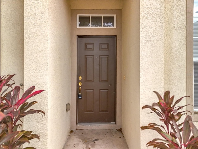 entrance to property with stucco siding