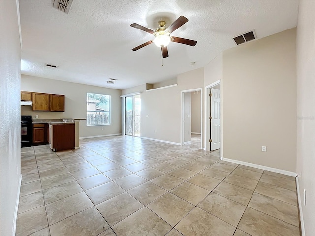 unfurnished living room featuring light tile patterned floors, a textured ceiling, visible vents, and a ceiling fan