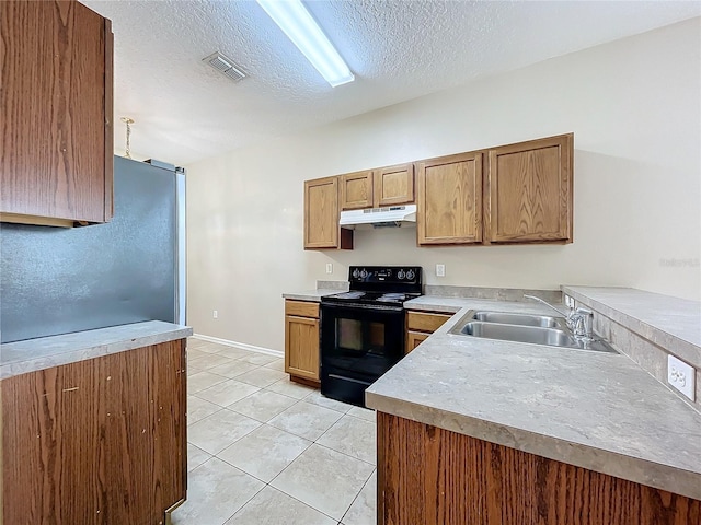 kitchen featuring visible vents, black range with electric stovetop, light tile patterned flooring, a sink, and under cabinet range hood