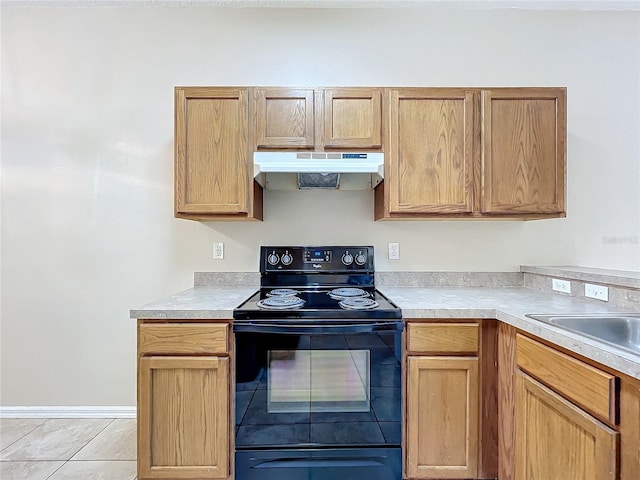 kitchen featuring light countertops, black range with electric stovetop, under cabinet range hood, and light tile patterned flooring