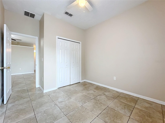 unfurnished bedroom featuring light tile patterned floors, a closet, and visible vents