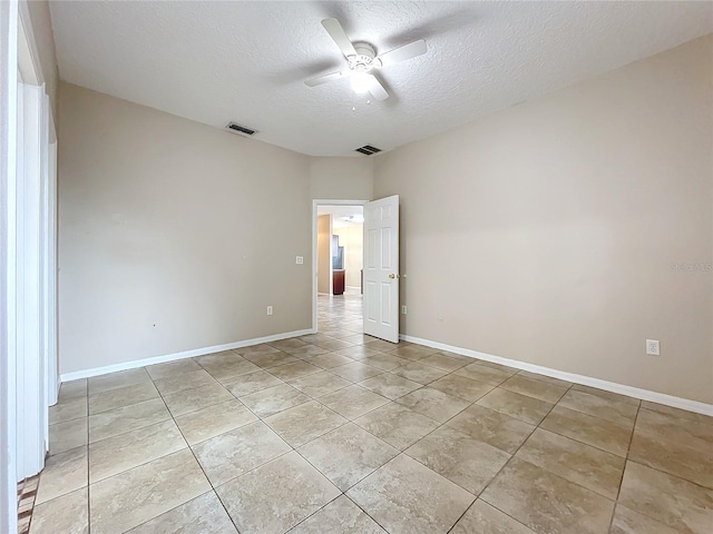 unfurnished room with baseboards, a textured ceiling, visible vents, and a ceiling fan