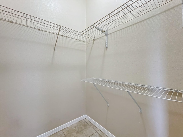 walk in closet featuring light tile patterned floors