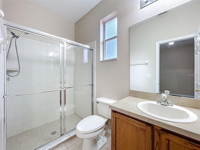 bathroom with toilet, tile patterned flooring, a textured ceiling, vanity, and a shower stall