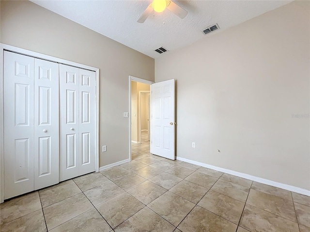 unfurnished bedroom featuring a closet, light tile patterned flooring, visible vents, and baseboards