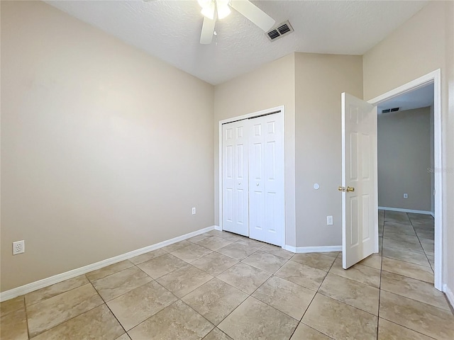 unfurnished bedroom featuring baseboards, a textured ceiling, visible vents, and a closet