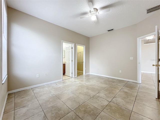 unfurnished room featuring visible vents, ceiling fan, and light tile patterned flooring