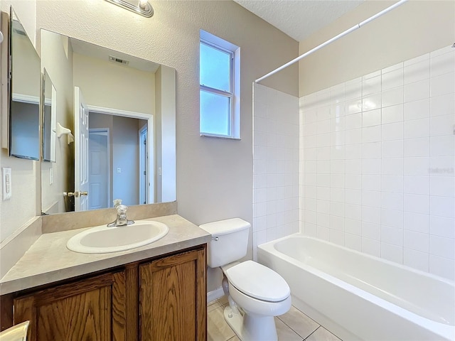 bathroom with visible vents, toilet, vanity, a textured ceiling, and tile patterned floors