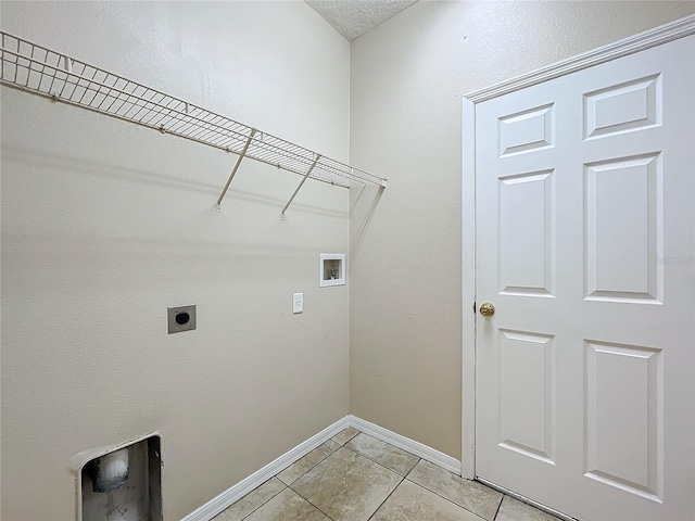 laundry area with light tile patterned flooring, hookup for a washing machine, hookup for an electric dryer, laundry area, and baseboards