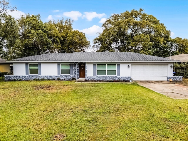 ranch-style house with a garage, concrete driveway, a front lawn, and stucco siding