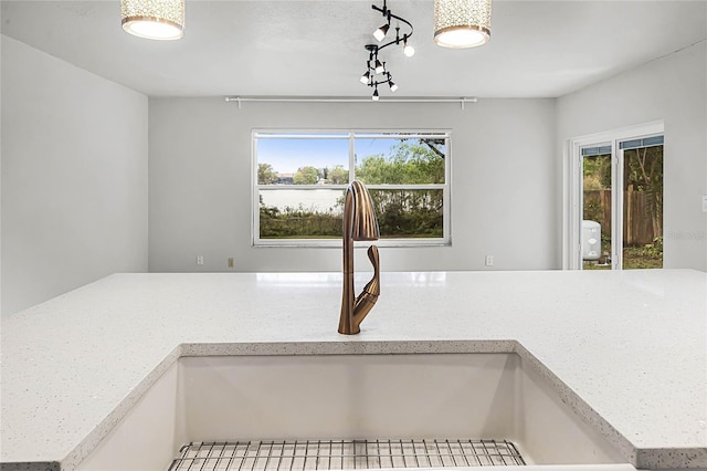 room details with a sink and light stone countertops