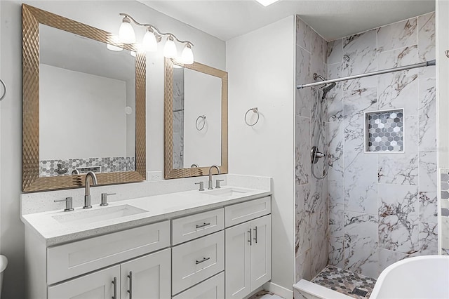 full bathroom featuring double vanity, a freestanding tub, a sink, and tiled shower