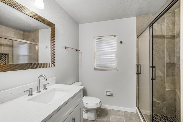 bathroom with toilet, a shower stall, a textured ceiling, and vanity