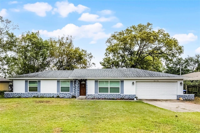 ranch-style home with a garage, a front yard, concrete driveway, and stucco siding