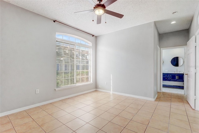 spare room with light tile patterned floors, ceiling fan, a textured ceiling, recessed lighting, and baseboards