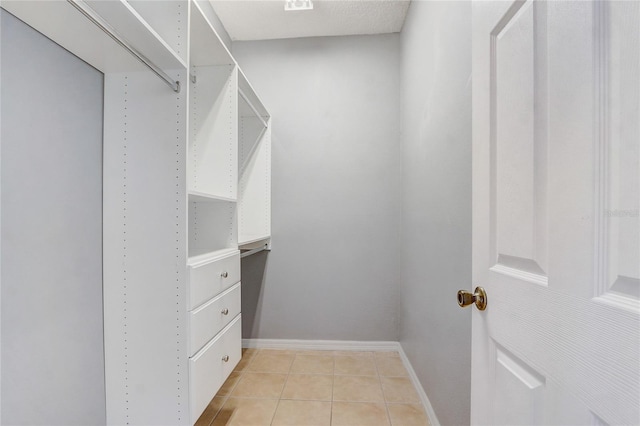 walk in closet featuring light tile patterned floors