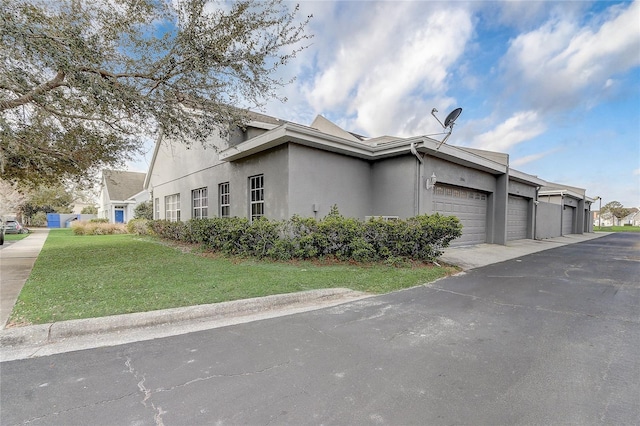 view of property exterior with a yard and stucco siding