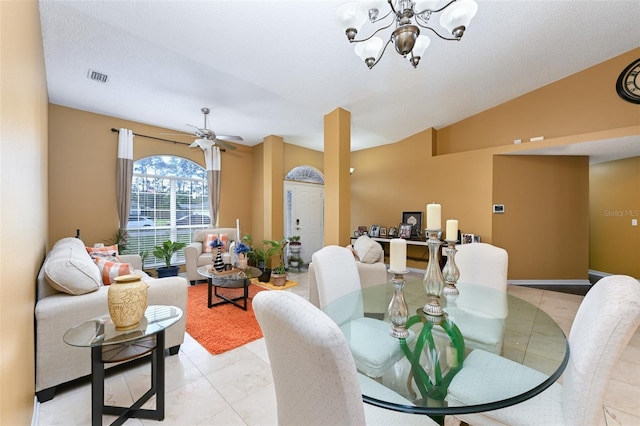 dining room with ceiling fan with notable chandelier, vaulted ceiling, a textured ceiling, and visible vents