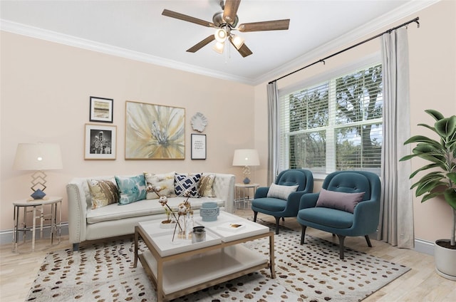 living area featuring ceiling fan, baseboards, wood finished floors, and crown molding