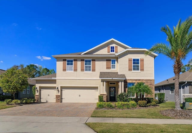 craftsman inspired home featuring stone siding, decorative driveway, an attached garage, and stucco siding