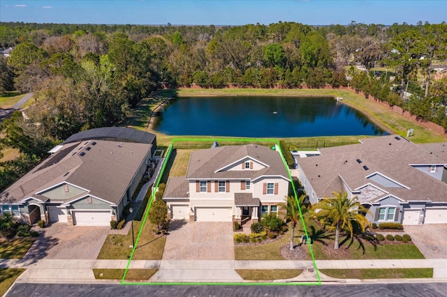 aerial view with a water view, a wooded view, and a residential view