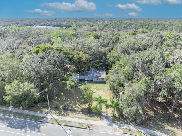 birds eye view of property featuring a wooded view